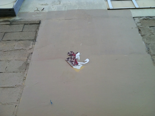 Puzzle piece, brown with red ants, by Béa Pyl. Rue de Candie. Dec 11 '12.